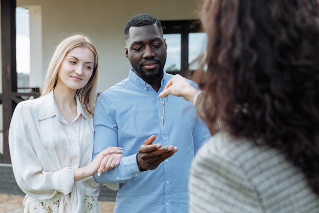 a%20landlord%20handing%20keys%20to%20two%20new%20residents